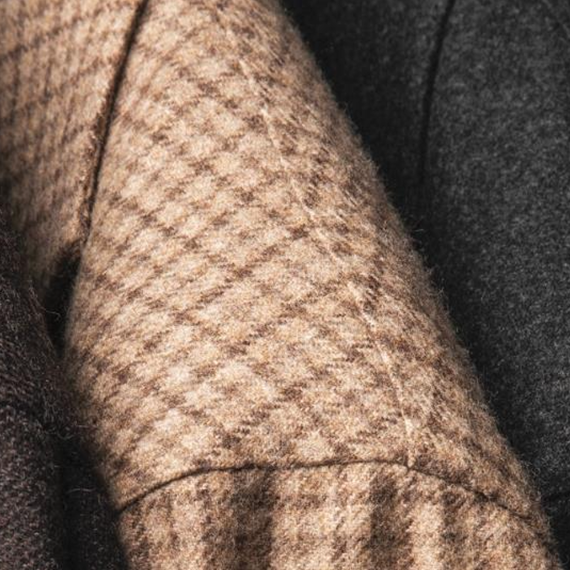 Close-up of the shoulder of a beige checked jacket